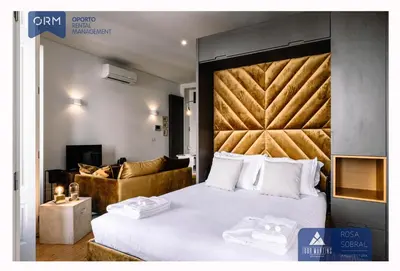 a bedroom with a large bed with a large headboard at ORM - Camões Apartment in Porto
