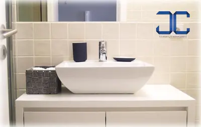 a white sink in a bathroom with a mirror at #Four Apartment by JC in Porto