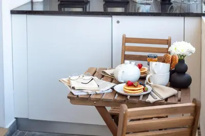 a wooden table with a plate of food on it at LovelyStay - Boavista Cozy Apartment in Porto