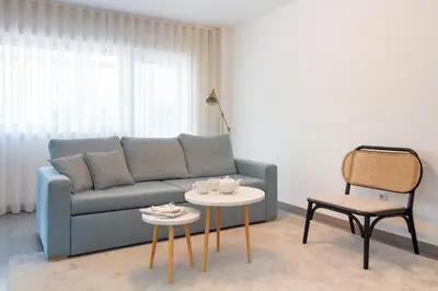 a living room with a couch and a table at LovelyStay - Boavista Cozy Apartment in Porto