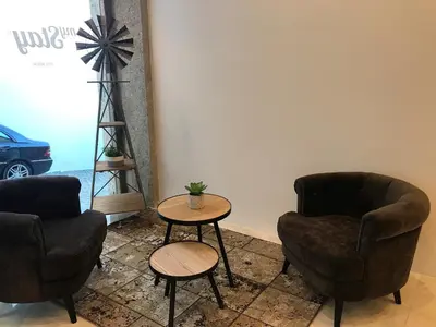 a bedroom with a bed with a window and a chair at Mystay Porto Batalha in Porto