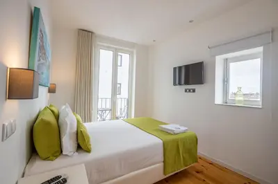 a gray building with a black door and windows at Mystay Porto Batalha in Porto