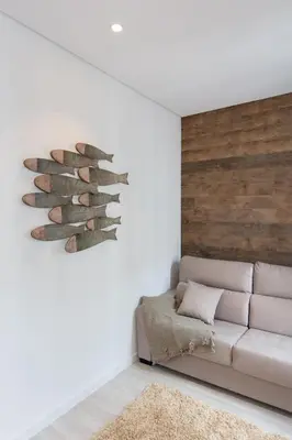 a living room with a couch and a wall at Porto Deluxe Suites in Porto