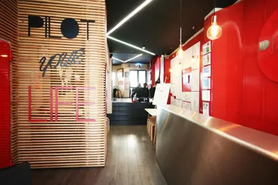 a restaurant with a bar with a no sign on the wall at PILOT Design Hostel & Bar in Porto