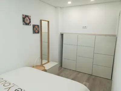a bedroom with a white bed and a mirror at Kris Apartments Porto in Porto