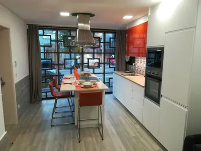 a kitchen with a table and some chairs in it at Kris Apartments Porto in Porto