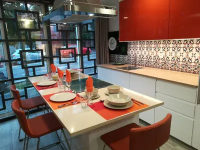 a kitchen with a table with plates and utensils at Kris Apartments Porto in Porto