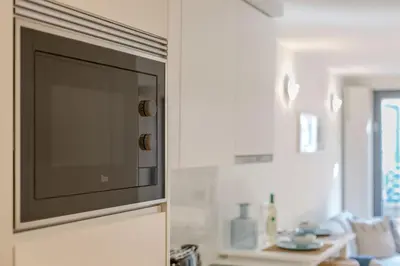 a living room with a couch and a fireplace at Downtown Porto Flat, Walk to City Center in Porto