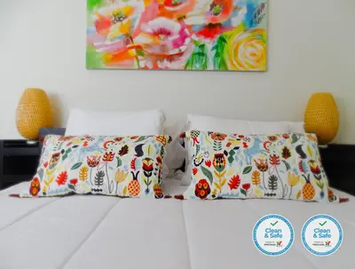 a bed with two pillows and a painting on the wall at RS Porto Vilar in Porto