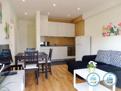 a living room and kitchen with a table and a couch at RS Porto Vilar in Porto