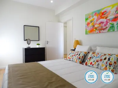 a bedroom with a bed and a painting on the wall at RS Porto Vilar in Porto