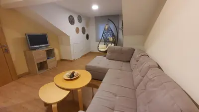 a living room with a couch and a table at Downtown Porto with PARKING next to subway in Porto