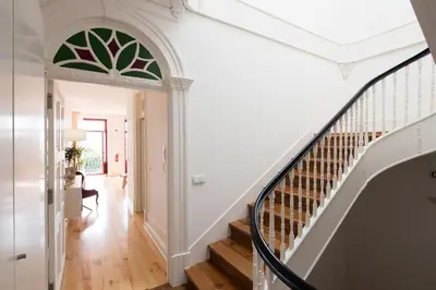 an arched hallway with a stairway with a white wall at LovelyStay - Martires Boutique Flat in Porto