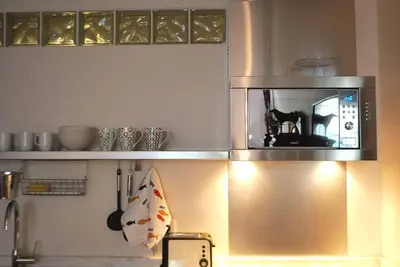 a microwave above a stove in a kitchen at Casa Braancamp - Beautiful & Calm in Porto