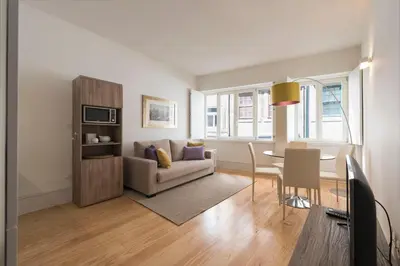 a living room with a table and a couch at BmyGuest - Villa Lóios Terrace Apartment in Porto