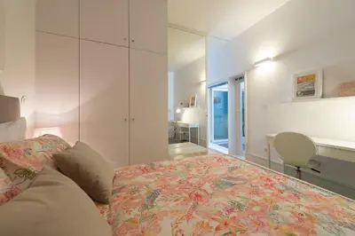 a bedroom with a bed and a desk and a window at BmyGuest - Villa Lóios Terrace Apartment in Porto