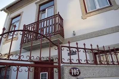 a building with a balcony and a sign on it at Oporto Living Apartments in Porto