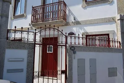 a building with a red door and a balcony at Oporto Living Apartments in Porto