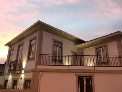 a house with a balcony on top of it at Oporto Living Apartments in Porto