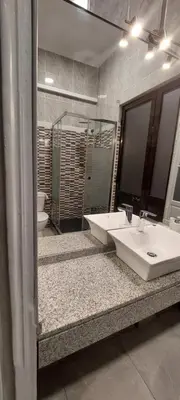 a bathroom with two sinks and a large mirror at Residencial Sol da Nave in Porto