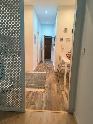 a hallway with a door leading to a dining room at Calm In Formosa in Porto