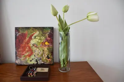 a vase with a flower in it next to a painting at Sé Boutique Apartment in Porto