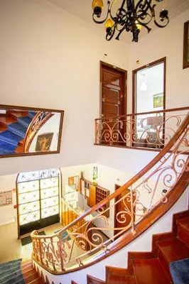 a staircase in a home with a chandelier at Hotel Borsalino in Porto