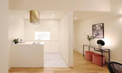 a kitchen with white walls and a white counter top at HM - Ribeira São João 2D in Porto