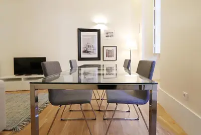 a dining room with a glass table and chairs at HM - Ribeira São João 2D in Porto