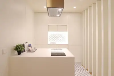 a kitchen with a white counter and a window at HM - Ribeira São João 2D in Porto