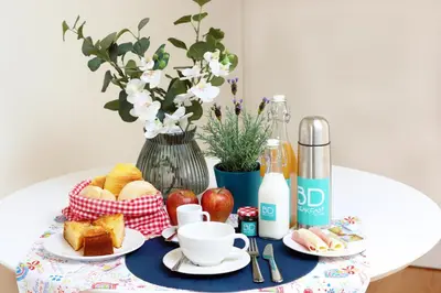 a table topped with a plate of bread and fruit at HM - Ribeira São João 2D in Porto