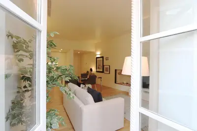 a living room with a white couch and a table at HM - Ribeira São João 3F in Porto