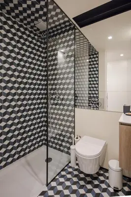 a bathroom with a toilet and a glass shower at HM - Ribeira São João 3F in Porto