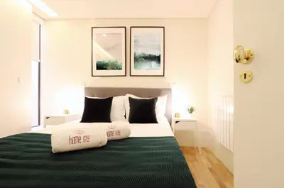 a bed with two pillows on it in a bedroom at HM - Ribeira São João 5K in Porto