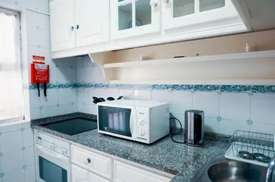 a kitchen with a microwave on a counter at Casa do Avô in Porto