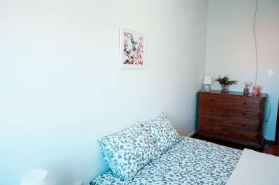 a bedroom with a bed with a pillow and a dresser at Casa do Avô in Porto