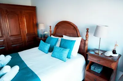 a bedroom with a bed with blue and white pillows at Casa do Avô in Porto