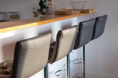 a row of black chairs at a kitchen counter at LovelyStay - Oren Duke's House in Porto