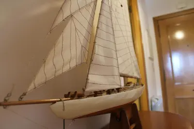 a model of a sail boat hanging on a wall at Galizia Flat in Porto