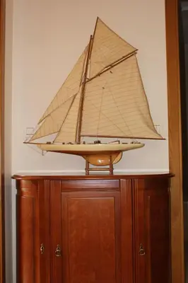 a model of a boat on top of a wooden cabinet at Galizia Flat in Porto