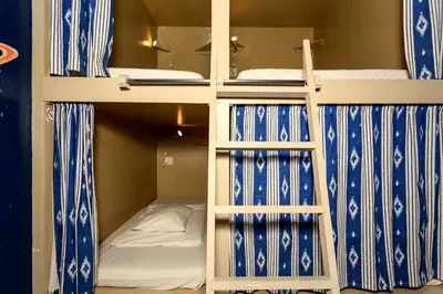 two bunk beds in a room with a bed at SUPERNOVA Hostel in Porto