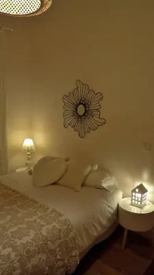 a bedroom with a bed with a flower clock on the wall at Casa Braancamp II - Chic & Sweet in Porto