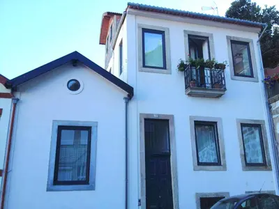 a white building with a balcony and a window at Casa Braancamp II - Chic & Sweet in Porto