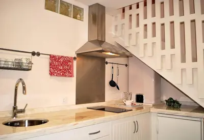 a kitchen with a sink and a staircase at Casa Braancamp II - Chic & Sweet in Porto
