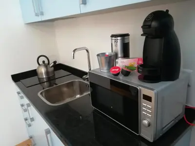 a microwave sitting on top of a kitchen counter at J3M Houses in Porto