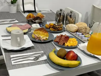 a table with many plates of food on it at Guest House Triunfo in Porto