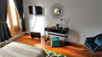 a room with a desk and a chair and a mirror at Cool Guesthouse in Porto