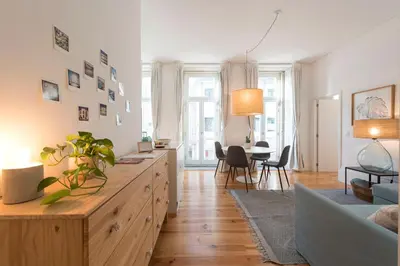 a living room with a wooden dresser and a table at Light Blue Apartment in Porto