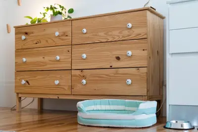 a chest of drawers with a dog bed in front of it at Light Blue Apartment in Porto