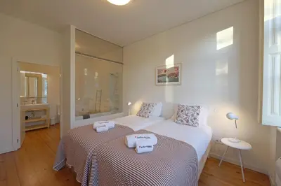 a bedroom with two beds with towels on them at FLH Oporto Captain House in Porto